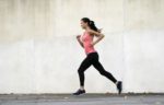 young-woman-running-in-urban-setting-high-res-stock-photography-537657173-1566593990