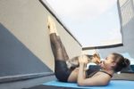 chinese-woman-practicing-yoga-with-dog-on-deck-royalty-free-image-543194915-1539710619