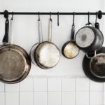 pots-and-pans-hanging-on-a-kitchen-wall-royalty-free-image-1588173908