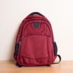red-backpack-on-hardwood-floor-against-wall-royalty-free-image-1588171880