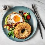 bagel-sandwich-with-avocado-fried-egg-and-side-royalty-free-image-1624469257