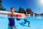 Women exercising with dumbbells in swimming pool